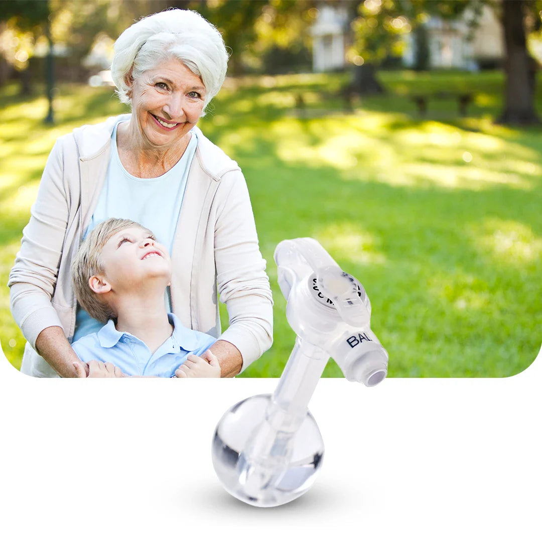 Woman and child in a park with a baby bottle labeled 'Babymoov' in the foreground.