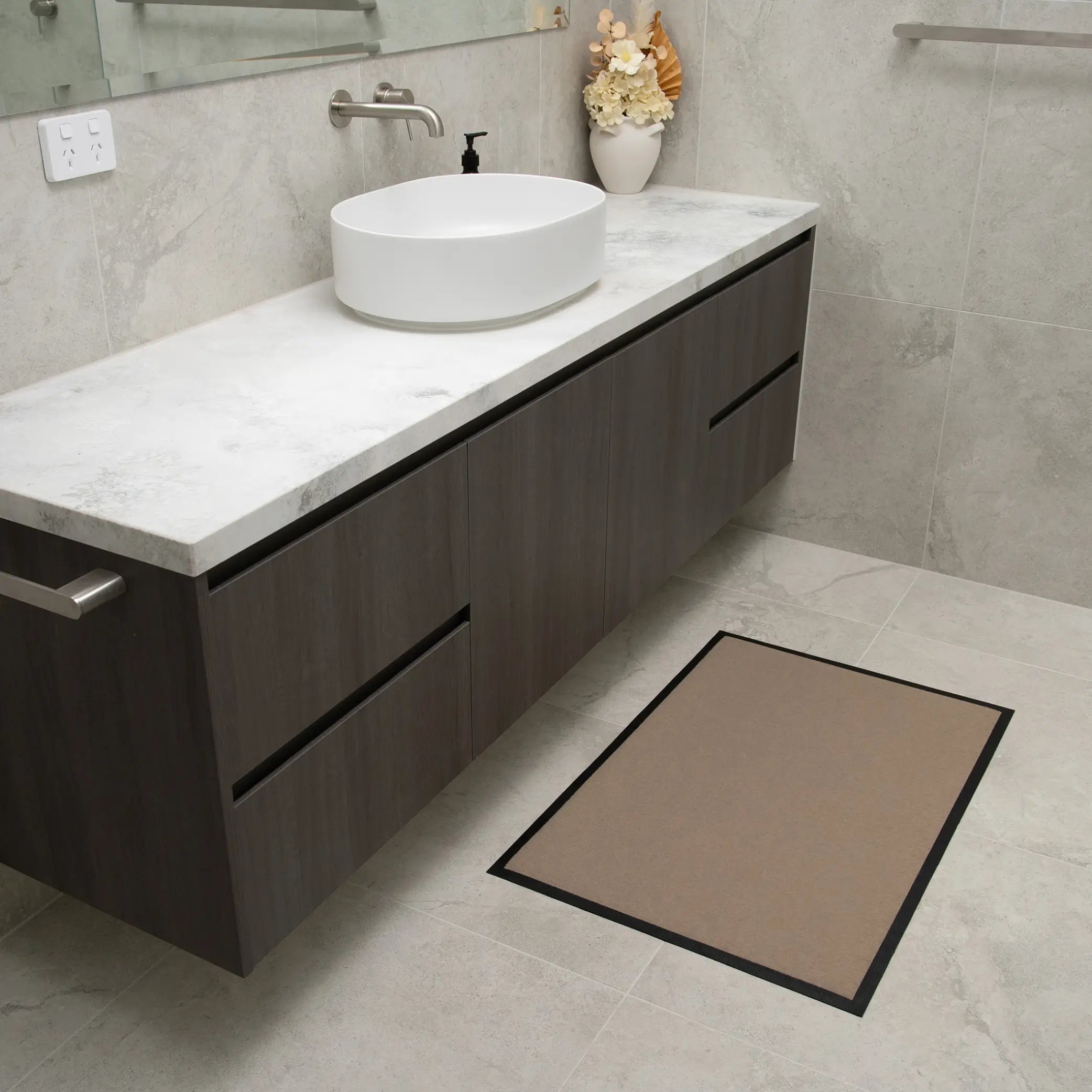 Non-slip waterproof floor mat in a stylish beige design with a black border, perfect for bathrooms and high-traffic areas. This absorbent, quick-dry mat provides a safe, slip-resistant surface while protecting floors from moisture and spills. Ideal for elderly care, incontinence support, or everyday home use.