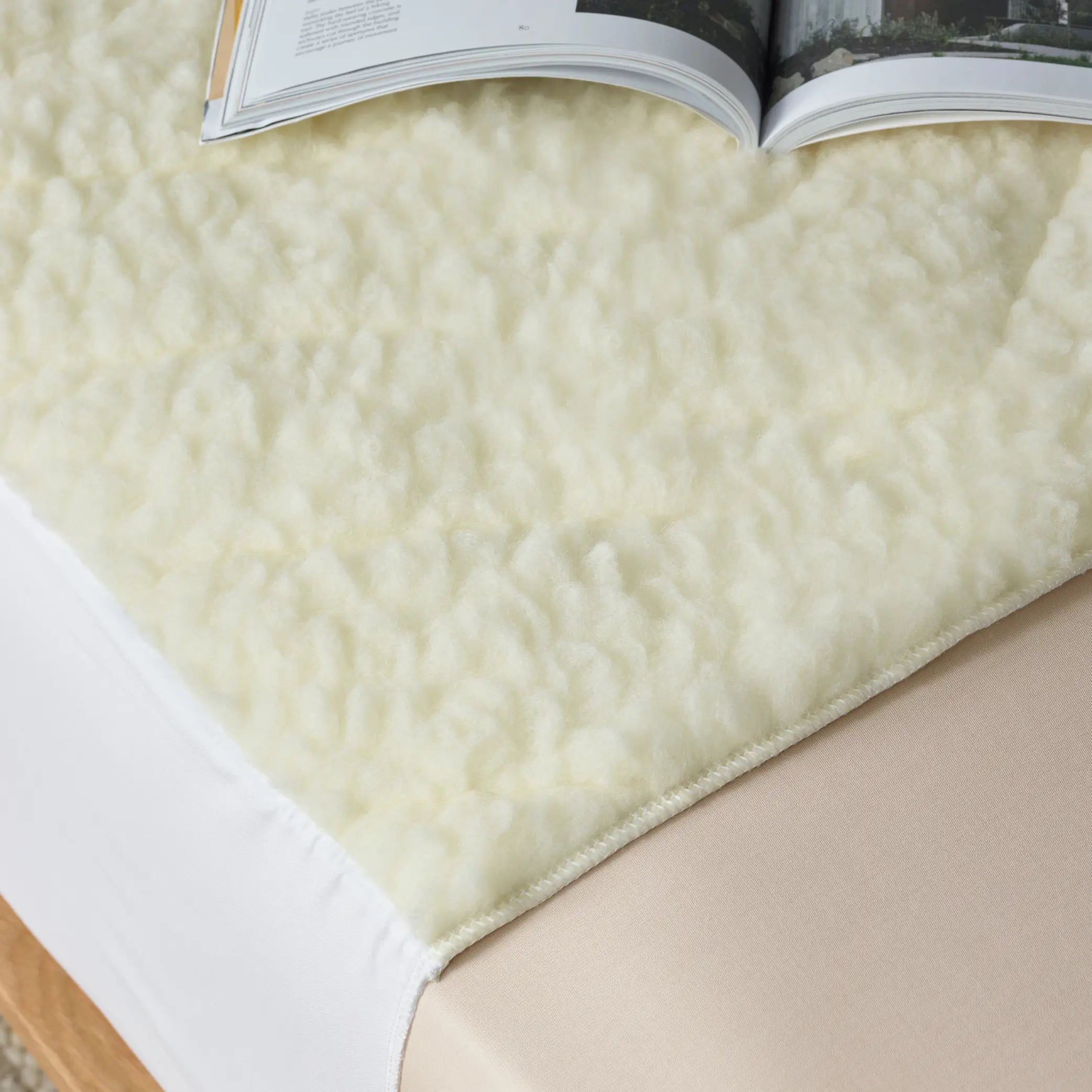 Close-up of a plush waterproof wool mattress topper also known as kylie bed pad  with soft, breathable fleece texture, designed for ultimate comfort and mattress protection. Ideal for temperature regulation and moisture control, this hypoallergenic topper enhances sleep quality 