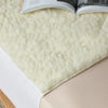 Close-up of a plush waterproof wool mattress topper also known as kylie bed pad  with soft, breathable fleece texture, designed for ultimate comfort and mattress protection. Ideal for temperature regulation and moisture control, this hypoallergenic topper enhances sleep quality 