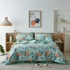 Bedroom featuring a luxurious water-resistant quilt cover set with a native Australian floral print in green and orange tones. 