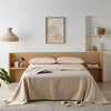 Elegant bedroom featuring a waterproof bamboo sheet set in a soft neutral tone. The breathable, hypoallergenic sheets provide a silky feel while protecting the mattress from spills and stains.