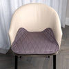 Grey waterproof chair pad with a quilted design placed on a beige upholstered chair, providing a comfortable and protective layer against spills, leaks, and daily wear. Perfect for dining chairs, office chairs, wheelchairs, and incontinence support.