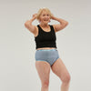 Confident older woman wearing StayDry full brief underwear in blue, designed for comfort, waterproof protection and incontinence support, ensuring style and security for everyday wear.