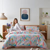 Bright and colourful Wonderlust by Deb McNaughton waterproof quilt cover set in a modern bedroom. This limited-edition bedding features an abstract, artistic print with soft pastel hues, adding a vibrant touch to any space. Designed with a waterproof layer for ultimate protection and durability.